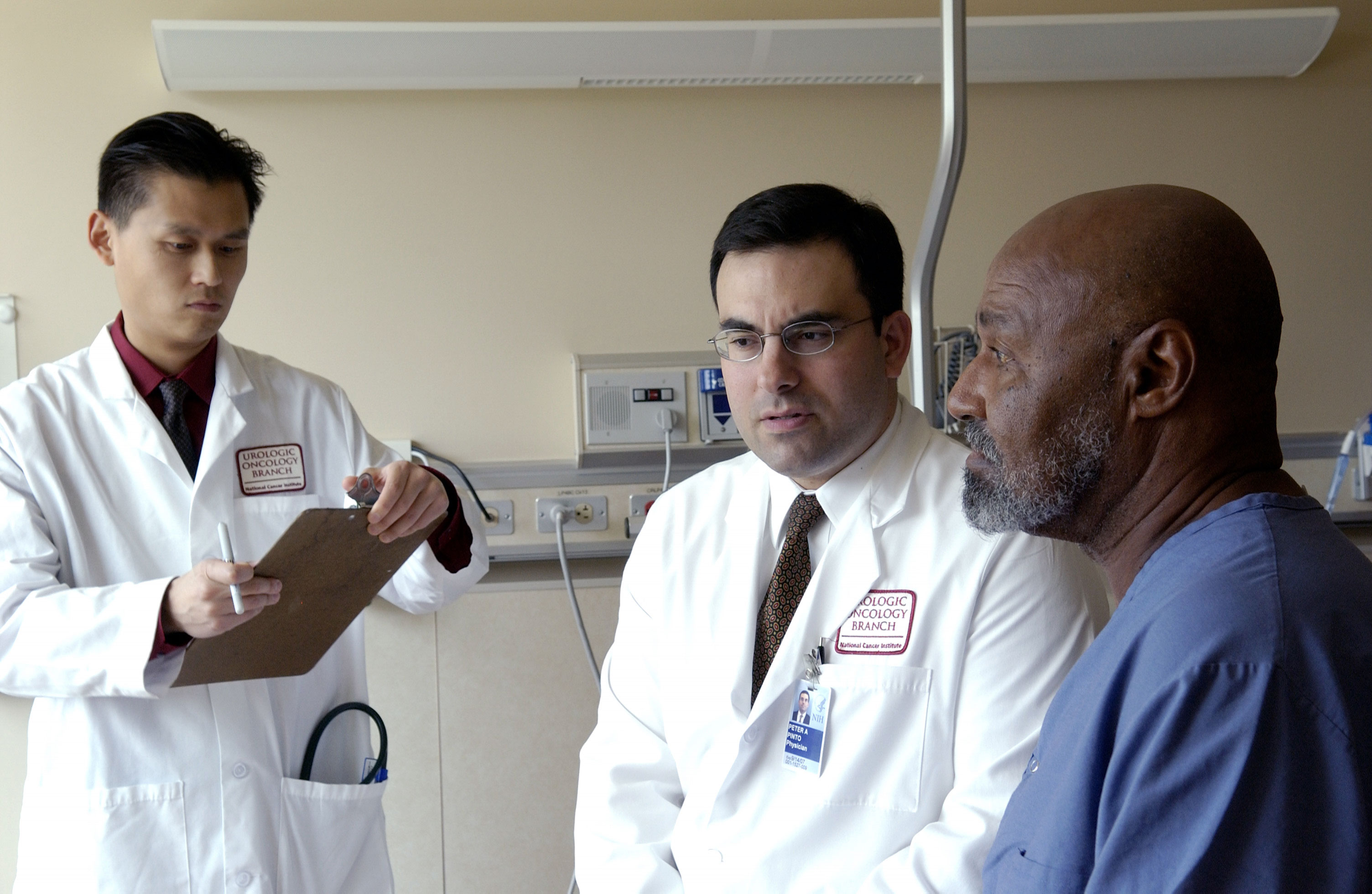 Doctor consulting with a patient in a clinical oncology setting
